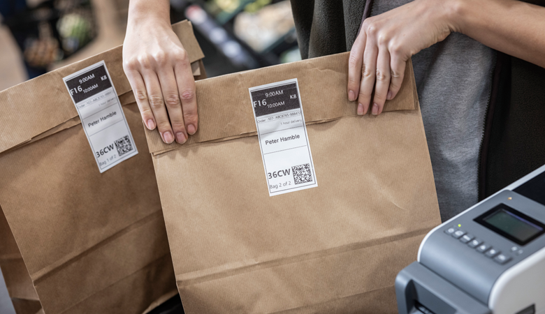 paper bags labelled with mobile order labels.