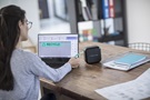 Woman with laptop and P-touch CUBE Plus
